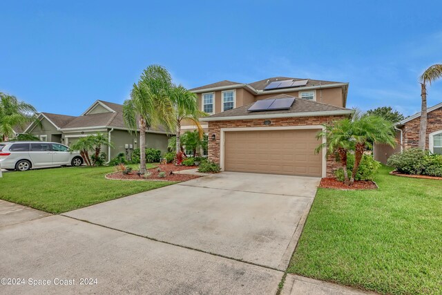 view of front of home featuring a garage and a front lawn