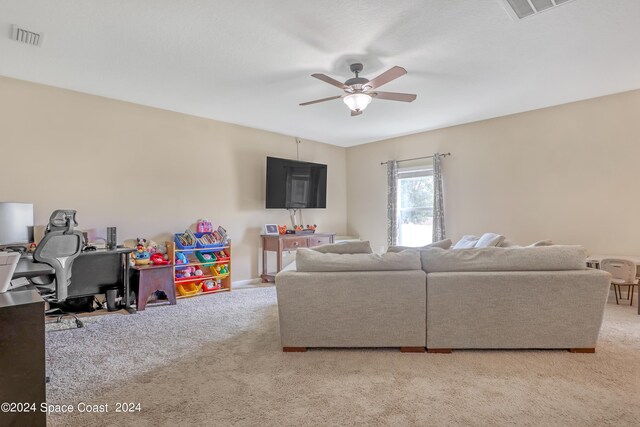 living room featuring light carpet and ceiling fan