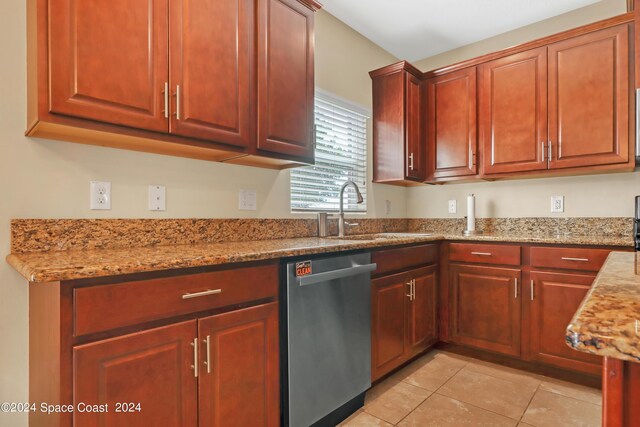 kitchen featuring light tile patterned floors, light stone countertops, dishwasher, and sink