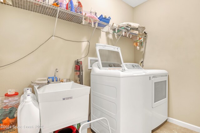 washroom featuring washing machine and clothes dryer and sink