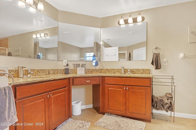 bathroom with tile patterned floors and vanity