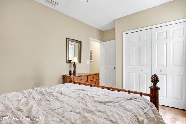 bedroom with a closet and light hardwood / wood-style flooring