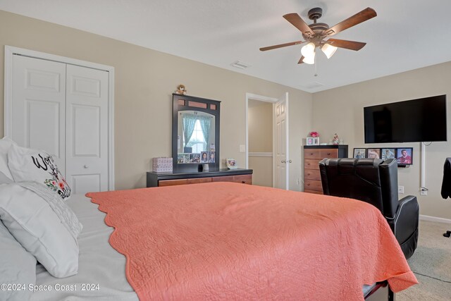 bedroom with a closet, ceiling fan, and carpet floors