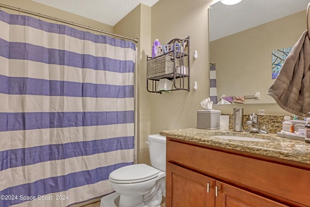 bathroom with vanity, toilet, and a shower with shower curtain