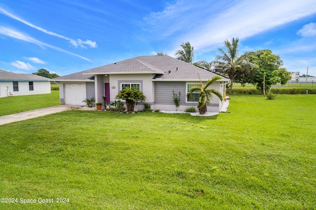 view of front of property featuring a front lawn and a garage