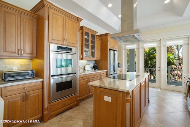 kitchen with stainless steel appliances, light tile patterned floors, island range hood, backsplash, and a center island