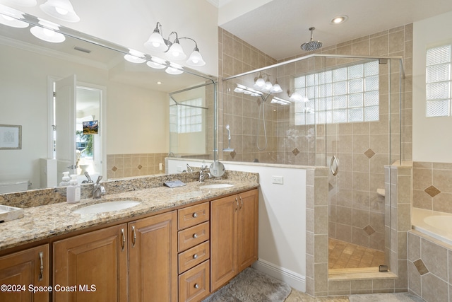 bathroom featuring a wealth of natural light, independent shower and bath, and ornamental molding