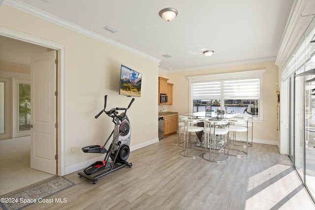 interior space with ornamental molding and light hardwood / wood-style floors