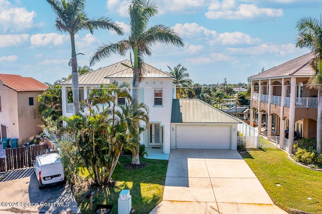 view of front of home featuring a garage and a front lawn