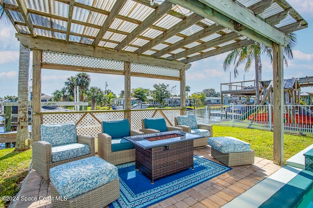 view of patio / terrace with an outdoor living space with a fire pit and a playground