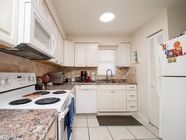 kitchen featuring light tile patterned floors, white appliances, white cabinetry, sink, and tasteful backsplash