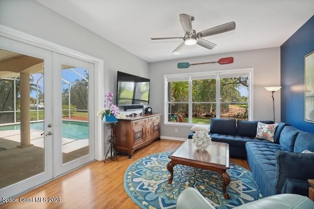 living room with french doors, hardwood / wood-style flooring, and ceiling fan