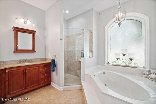 bathroom with tile patterned flooring, vanity, a chandelier, and plus walk in shower