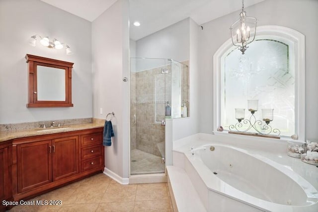 bathroom featuring tile patterned floors, a tub with jets, a shower stall, and vanity