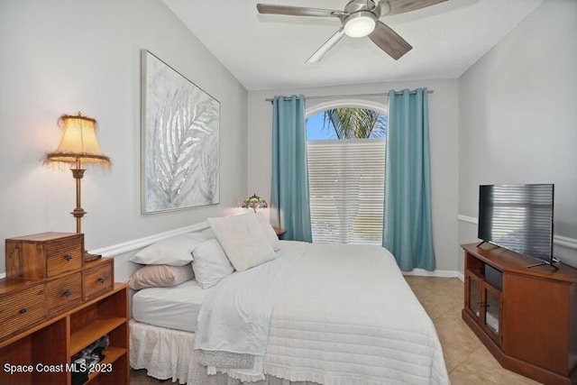 bedroom with light tile patterned floors, baseboards, and ceiling fan