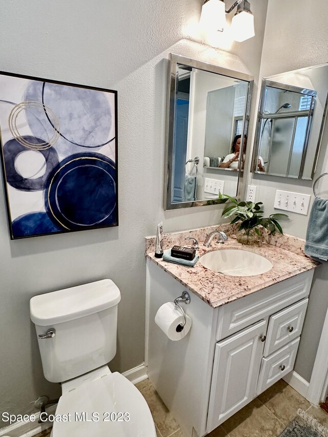 bathroom with tile patterned floors, toilet, and vanity