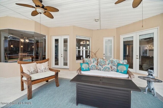 sunroom with ceiling fan and french doors