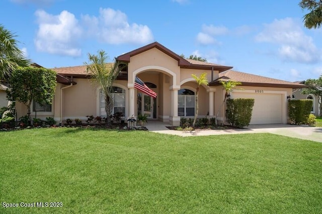 mediterranean / spanish-style house featuring a garage, stucco siding, concrete driveway, and a front yard