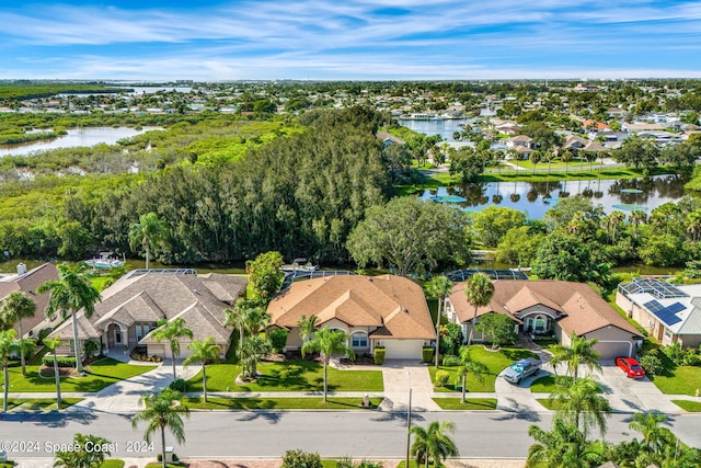 drone / aerial view with a residential view and a water view