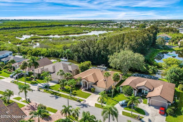 drone / aerial view with a residential view and a water view