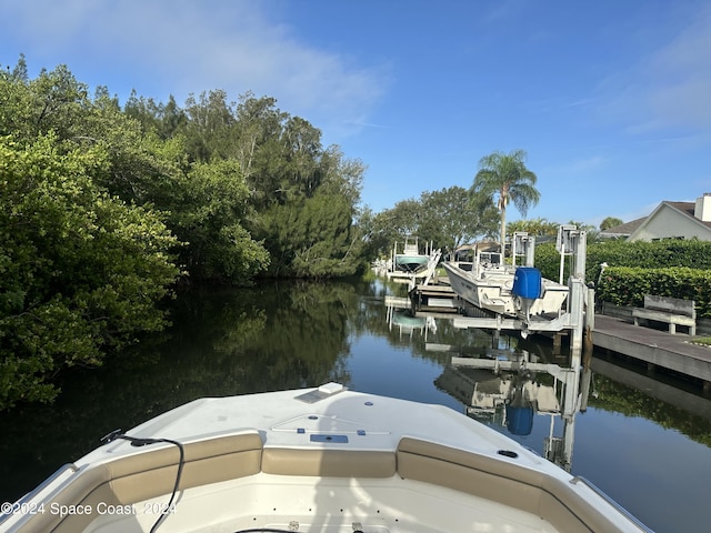 dock area with a water view and boat lift