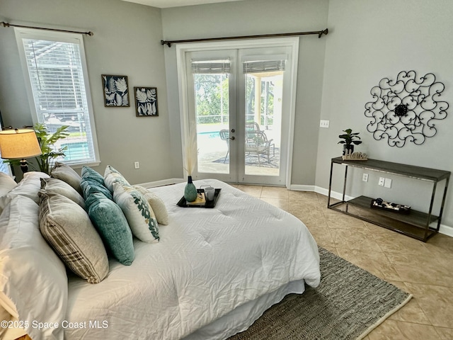 bedroom featuring tile patterned flooring, french doors, baseboards, and access to outside