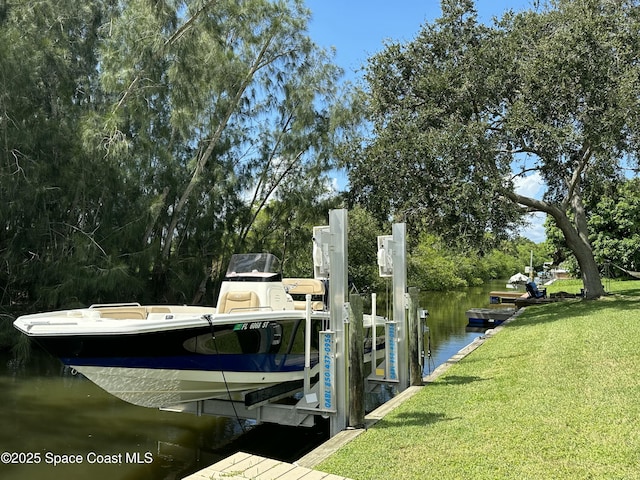 dock area featuring a yard, a water view, and boat lift