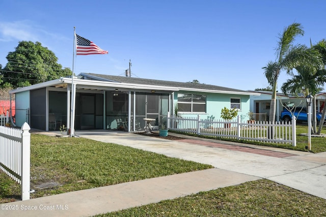 view of front of home with a carport and a front lawn