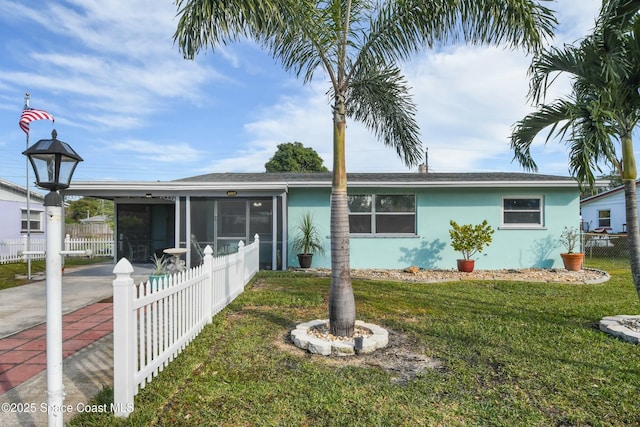 single story home with a front yard and a sunroom