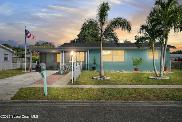 view of front of house with a yard and a carport