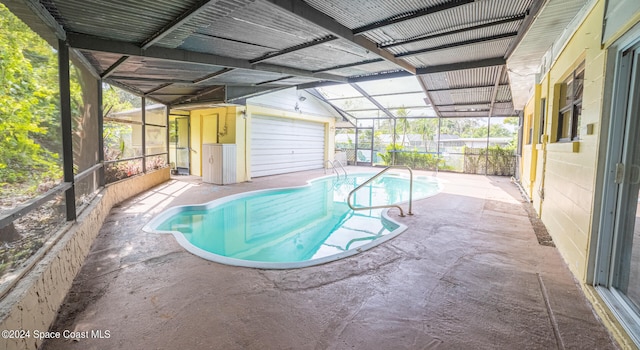 view of swimming pool with a patio area, a lanai, and an outbuilding