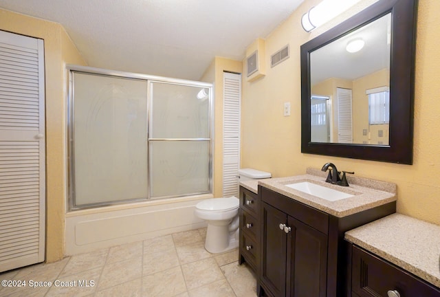 full bathroom featuring vanity, toilet, tile patterned floors, and shower / bath combination with glass door