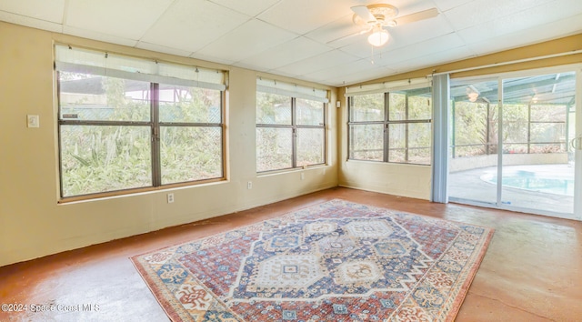 sunroom with ceiling fan and vaulted ceiling