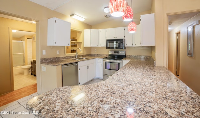 kitchen with sink, white cabinetry, stainless steel appliances, vaulted ceiling, and pendant lighting