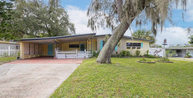 ranch-style house with a front yard and a carport