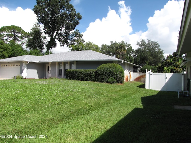 view of front of home featuring a garage and a front lawn