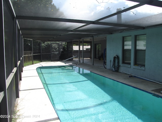 view of swimming pool with a lanai and a patio area