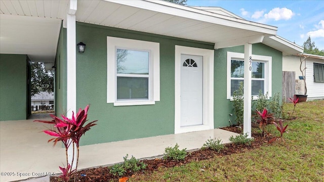 doorway to property with a yard