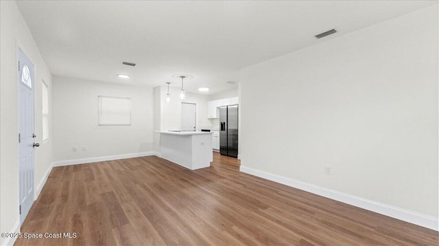 unfurnished living room featuring light hardwood / wood-style floors