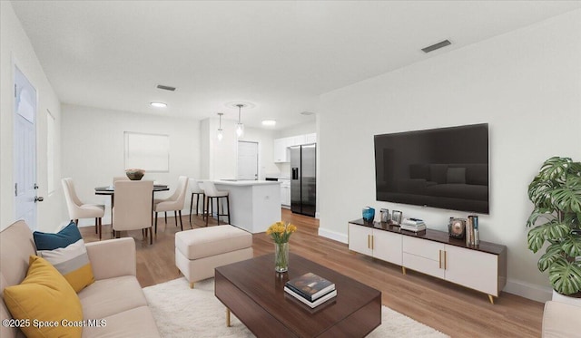 living room with light hardwood / wood-style flooring