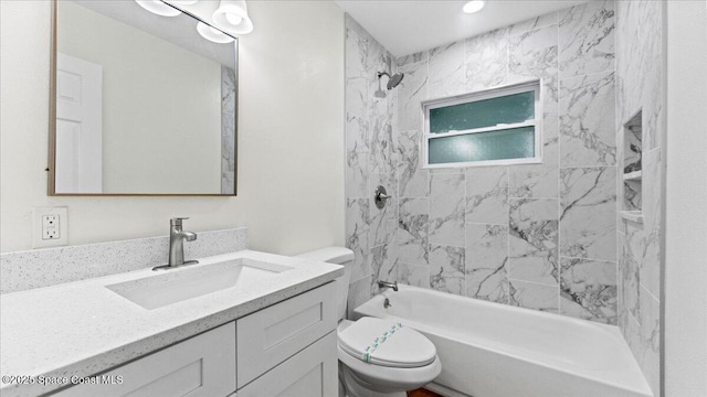 full bathroom with vanity, toilet, and tiled shower / bath combo