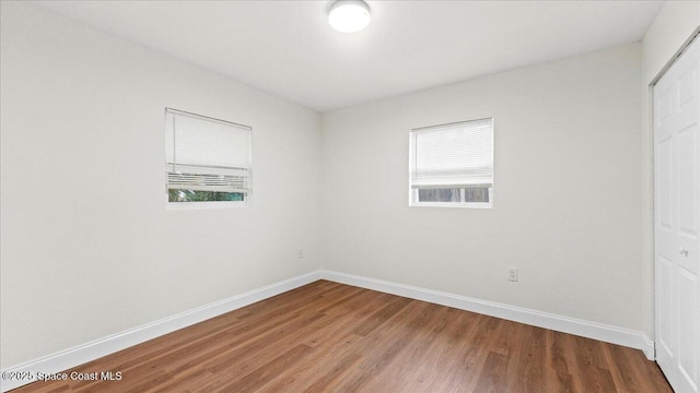 unfurnished room featuring hardwood / wood-style floors and a wealth of natural light