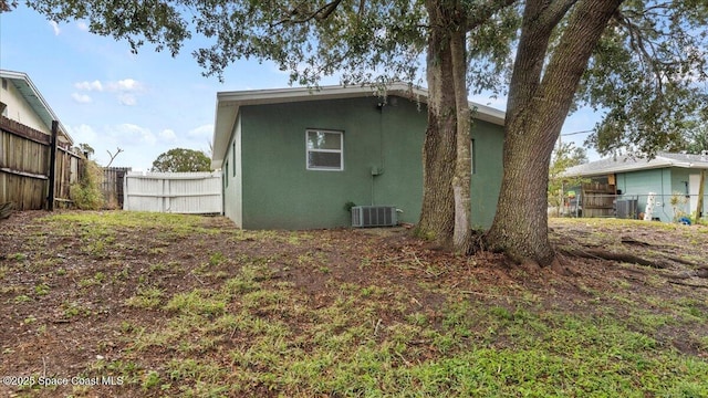 rear view of house featuring cooling unit