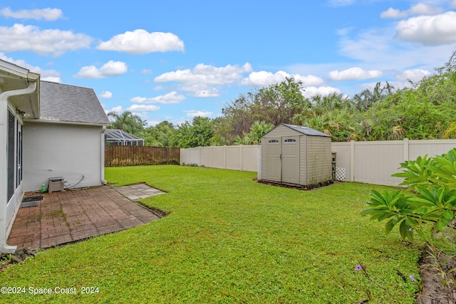 view of yard with a storage unit and a patio area