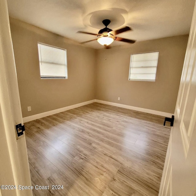 empty room featuring ceiling fan and light hardwood / wood-style floors