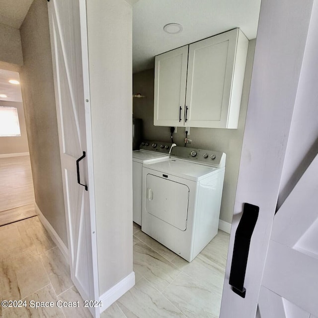 laundry area featuring cabinets and independent washer and dryer