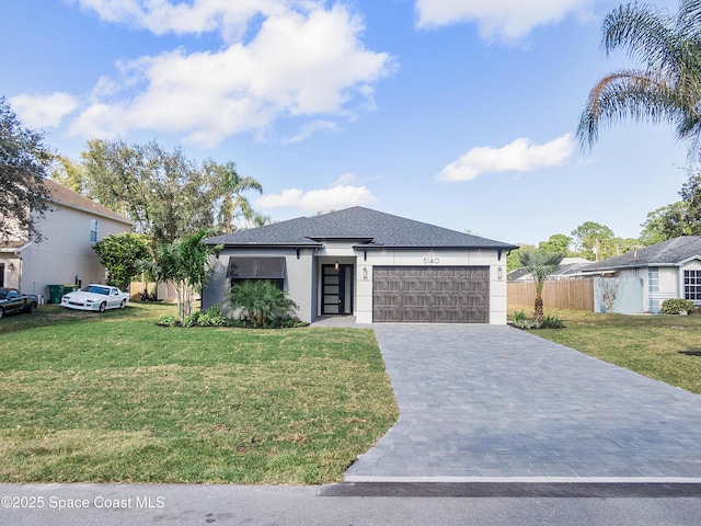 view of front of home with a garage and a front yard