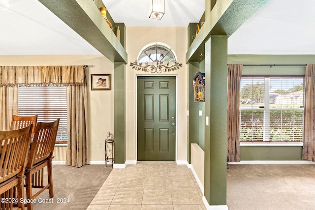 foyer entrance with light colored carpet