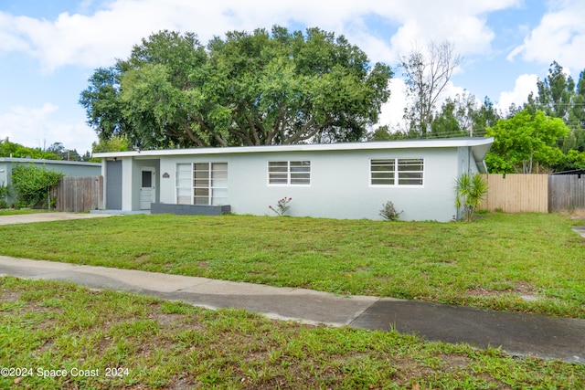 ranch-style home with a front lawn