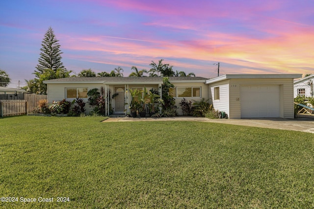 single story home featuring an attached garage, driveway, a front lawn, and fence